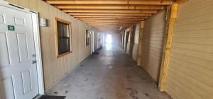 an empty hallway of a building with a door and a hallwayngthngthngthngth at Werry's Cottages and Pub By OYO East Stroudsborg - Weekly Stays in East Stroudsburg