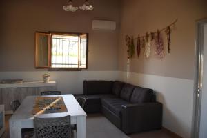 a living room with a couch and a table at La Corte dell’Isola in Pachino
