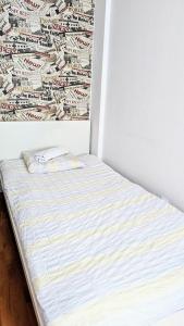a bed sitting in a corner of a room at Ursus Rooms-Self Check-in in Warsaw