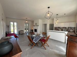 a kitchen and living room with a table and chairs at Agrihouse Fronte mare Torre dell'Orso in Lecce