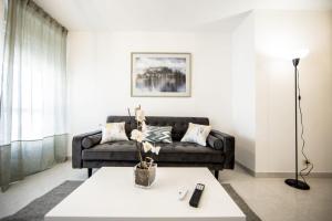 a living room with a couch and a table at Dulces Estancias in Lalín