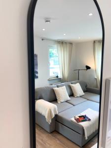 a living room with a couch in front of a mirror at Penthouse - Zentral und Genial in Passau +50 photos