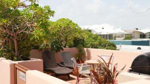 a balcony with two chairs and a table and trees at Acanto Hotel Playa del Carmen, Trademark Collection by Wyndham in Playa del Carmen