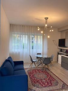 a living room with a blue couch and a table at Villa Romantika in Arco