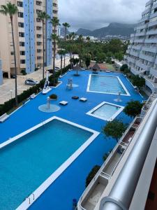 an overhead view of two swimming pools in a building at Service Apart Lazaro- Apartamentos Aguamarina 14 in Calpe