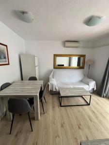 a room with a bed and a table and chairs at Service Apart Lazaro- Apartamentos Aguamarina 14 in Calpe