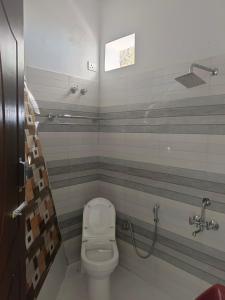 a bathroom with a toilet and a shower at Golden Oak Villa in Mussoorie