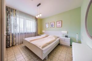 En eller flere senge i et værelse på Chiemgau Comfort C6 Ferienwohnanlage Oberaudorf mit Hallenbad und Sauna
