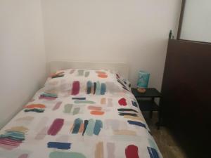 a bed with a colorful bedspread on it in a room at Alla marina in Fiumefreddo di Sicilia
