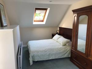 - une petite chambre avec un lit et un miroir dans l'établissement Temple Loft Studio, à Moate
