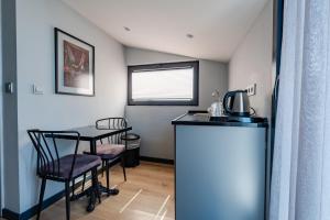 a small kitchen with a table and chairs in a room at The Row Taksim Hotel in Istanbul