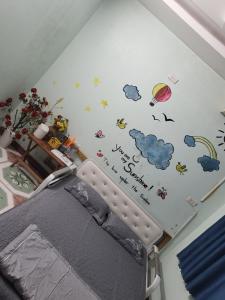 a bedroom with a bed with stickers on the wall at Golden Bell Backpacker Hostel in Ninh Binh