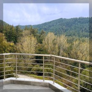 a balcony with a view of a mountain at Favelas Luxury Apartments in Kavála
