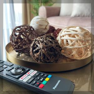 a remote control sitting next to a plate of balls at Favelas Luxury Apartments in Kavála +44 photos