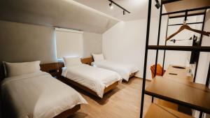 a bedroom with two beds and a window at BAZ'HUR Boutique Hotel in Kukës