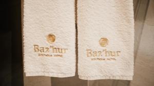 two towels with the words bar inn on them at BAZ'HUR Boutique Hotel in Kukës