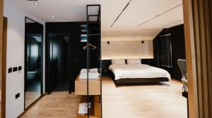 a bedroom with a bed and a mirror at BAZ'HUR Boutique Hotel in Kukës