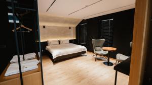 a bedroom with a bed and a table and chairs at BAZ'HUR Boutique Hotel in Kukës