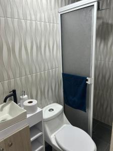 a small bathroom with a toilet and a sink at Habitaciones villa oti in Ciénaga