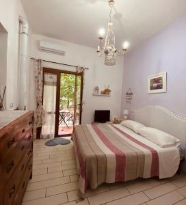 a bedroom with a bed and a chandelier at B&B Rifugio Angelina in Vietri sul Mare