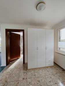 a room with a white cabinet and a door at Ludwigslust, deine Rückzugsoase in Mehltheuer