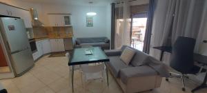 a living room with a couch and a table at Amdar Village Cottage עם ממ"ד in Eilat
