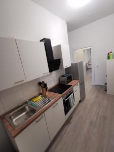 a kitchen with a sink and a stove top oven at Modern Apartment Hagen - Dortmund in Hagen
