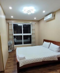 a bedroom with a bed and a window at Homestay Ha Long Luxury Apartment ( Ocean View) in Ha Long