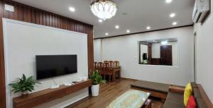 a living room with a flat screen tv on a wall at Homestay Ha Long Luxury Apartment ( Ocean View) in Ha Long