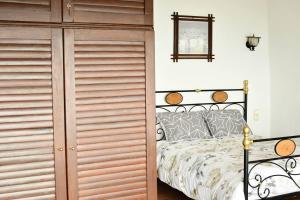 a bedroom with a bed and a wooden closet at Centaurs Spot in Makrinitsa