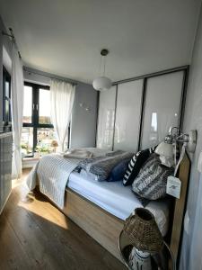 a bedroom with a large bed with a large window at Edel Exclusive Apartments Horyzont 414 Especially for You in Międzyzdroje