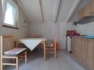 a kitchen with a table and chairs in a room at Guest House Dobriša in Vinišće +19 photos