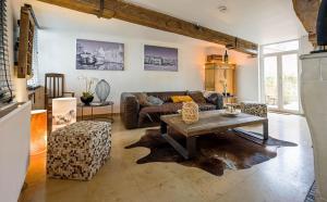 a living room with a couch and a table at Maison Gaston in Bruges