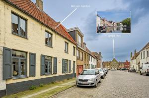 a city street with cars parked on the street at Maison Gaston in Bruges