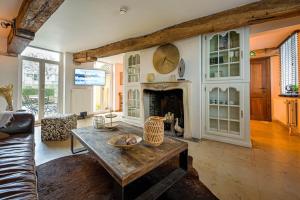 a living room with a table and a fireplace at Maison Gaston in Bruges