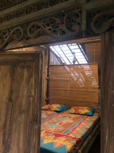 a wooden bunk bed in a room with a window at Omah Guyub 2 in Jarakan