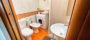 ein Badezimmer mit einem WC, einem Waschbecken und einer Waschmaschine in der Unterkunft Casa Flavia in Taormina
