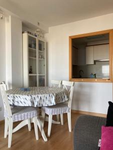 a dining room with a table and chairs at Beach Apartment in Vilanova i la Geltrú