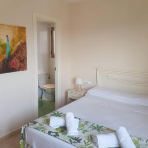 a bedroom with a bed with towels on it at Esmeralda Suites Calpe in Calpe +37 photos