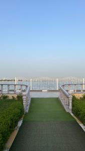 a balcony of a building with a green lawn at منتجع درة الشرق للعائلات in Dammam