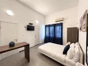 a bedroom with a bed and a table in it at Carmel Market center apartments TLV in Tel Aviv
