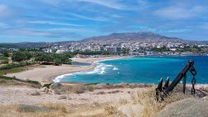 a view of a beach with a city in the background at Seaside Studio Meltemi in Rafina