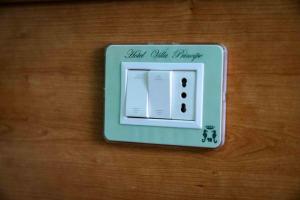 a lightswitch sitting on a wooden table at Hotel Villa Principe in San Nicola Arcella