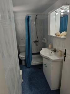 a bathroom with a shower and a toilet and a sink at Anna'sHouse in Agios Ioannis +154 photos