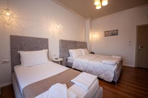 Postel nebo postele na pokoji v ubytování Hotel Murati