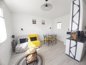 a living room with a couch and a table at Studio 2 à 4 personnes proche de la plage in La Guérinière