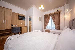 Postel nebo postele na pokoji v ubytování Hotel Murati