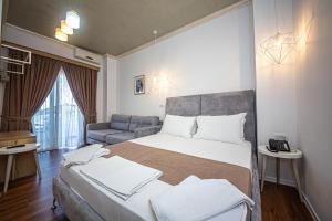 Postel nebo postele na pokoji v ubytování Hotel Murati