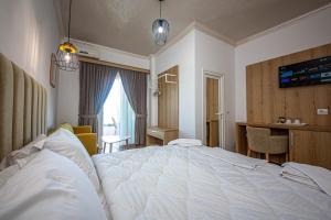 Postel nebo postele na pokoji v ubytování Hotel Murati