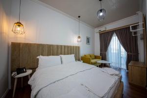 Postel nebo postele na pokoji v ubytování Hotel Murati